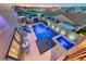 The backyard pool features a jacuzzi, several lounge chairs, and a retaining wall with modern lighting at 1523 Great Sands St, Boulder City, NV 89005