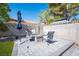 Relaxing backyard features pavers, artificial turf, shade and a central outdoor seating area with chairs at 1553 Bright View Dr, Las Vegas, NV 89119