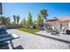 This backyard features a well-maintained lawn area, brick pavers, and space for outdoor seating at 1553 Bright View Dr, Las Vegas, NV 89119