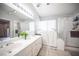 Modern bathroom features double vanity, walk-in shower, and walk-in tub, creating a spa-like retreat for relaxation and rejuvenation at 1553 Bright View Dr, Las Vegas, NV 89119