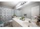 Bright bathroom boasts double sinks, modern fixtures, and stylish decor, creating a functional and aesthetically pleasing space at 1553 Bright View Dr, Las Vegas, NV 89119