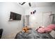 This simple bedroom has sliding door closet and flat screen television on the wall at 1553 Bright View Dr, Las Vegas, NV 89119