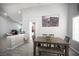 Bright dining area with a rustic wooden table and ample seating, adjacent to the kitchen and living spaces at 1553 Bright View Dr, Las Vegas, NV 89119