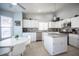Bright kitchen with granite countertops, white cabinetry, stainless steel appliances, and a cozy dining area at 1553 Bright View Dr, Las Vegas, NV 89119