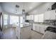 Updated kitchen features white cabinets, granite countertops, stainless steel appliances, and a center island at 1553 Bright View Dr, Las Vegas, NV 89119