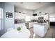 Modern kitchen boasts white cabinets, granite countertops, stainless steel appliances, and a charming breakfast nook for casual dining at 1553 Bright View Dr, Las Vegas, NV 89119