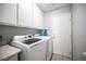This tidy laundry room features a washer, dryer, storage cabinets, and access to the outdoors at 1553 Bright View Dr, Las Vegas, NV 89119