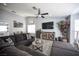 Cozy living room with plush sectional seating, modern decor, and stylish wood-look tile flooring at 1553 Bright View Dr, Las Vegas, NV 89119