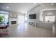 Spacious living room features a brick fireplace, a large television, and access to the dining area at 1553 Bright View Dr, Las Vegas, NV 89119