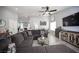 Open-concept living space featuring a plush gray sectional, a TV, and modern decor at 1553 Bright View Dr, Las Vegas, NV 89119