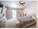 Relaxing main bedroom features neutral tones, plush carpet, and a sliding glass door providing access to the backyard oasis at 1553 Bright View Dr, Las Vegas, NV 89119