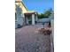 Backyard featuring a covered patio, small brick firepit, and gravel groundcover at 1617 Stonefield St, Las Vegas, NV 89144