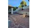 Serene backyard with stone landscaping, patio, and a decorative birdbath feature at 1617 Stonefield St, Las Vegas, NV 89144