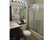 Cozy bathroom with shower-tub combination, a white toilet, and a dark cabinet sink at 1617 Stonefield St, Las Vegas, NV 89144