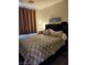 Bedroom featuring a bed, side tables, and a decorative headboard with storage space at 1617 Stonefield St, Las Vegas, NV 89144