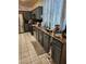 Kitchen featuring stainless steel appliances, grey cabinetry, granite counters, and tiled floor at 1617 Stonefield St, Las Vegas, NV 89144