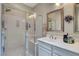 Bright bathroom with a glass-enclosed shower, double sinks, and modern fixtures at 169 Pioneer Peak Pl, Las Vegas, NV 89138