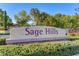 Sage Hills community sign surrounded by lush greenery at 169 Pioneer Peak Pl, Las Vegas, NV 89138