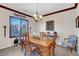 Traditional dining room with wood table, crown molding, and shuttered window at 169 Pioneer Peak Pl, Las Vegas, NV 89138
