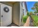 Charming front door with decorative wreath and lush landscaping at 169 Pioneer Peak Pl, Las Vegas, NV 89138