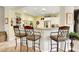 Open kitchen with breakfast bar, stainless steel appliances, and bright accents at 169 Pioneer Peak Pl, Las Vegas, NV 89138