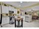 Bright kitchen features white cabinets, stainless steel appliances, and tile flooring at 169 Pioneer Peak Pl, Las Vegas, NV 89138