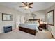 Calm main bedroom with an en-suite bathroom, neutral colors, and plantation shutters at 169 Pioneer Peak Pl, Las Vegas, NV 89138