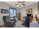 Well-lit office space with a ceiling fan, large desk, and comfortable chair at 169 Pioneer Peak Pl, Las Vegas, NV 89138