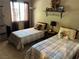 Inviting bedroom featuring two twin beds, soft lighting, and decorative wall accents at 1866 Camino Verde Ln, Las Vegas, NV 89119