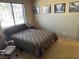 Cozy bedroom featuring natural light, carpet, and neutral paint with unique black and white city-themed art at 1866 Camino Verde Ln, Las Vegas, NV 89119