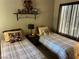 Inviting bedroom featuring two twin beds, soft lighting, and decorative wall accents at 1866 Camino Verde Ln, Las Vegas, NV 89119
