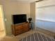 Bedroom featuring television with view into walk-in closet with plentiful storage racks at 1866 Camino Verde Ln, Las Vegas, NV 89119