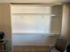 Walk-in closet featuring wall-mounted shelving, space for organizing clothing, and chair at 1866 Camino Verde Ln, Las Vegas, NV 89119