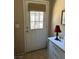 Door with window and blinds, adjacent to a dresser with a lamp and wall decor at 1866 Camino Verde Ln, Las Vegas, NV 89119