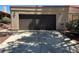 Exterior view of the two-car garage with brown garage door at 1866 Camino Verde Ln, Las Vegas, NV 89119