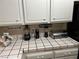 White tile countertops provide plentiful surface for appliances and food preparation in the kitchen at 1866 Camino Verde Ln, Las Vegas, NV 89119