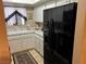 Classic kitchen featuring white cabinets, complementary countertops, and modern, black appliances at 1866 Camino Verde Ln, Las Vegas, NV 89119