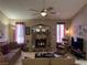 Well-lit living room featuring comfortable seating and a decorative stone fireplace at 1866 Camino Verde Ln, Las Vegas, NV 89119