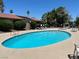 Community pool area with clear blue water and ample seating under the bright sky at 1866 Camino Verde Ln, Las Vegas, NV 89119