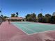 Well-maintained tennis court with vibrant green surface and classic net at 1866 Camino Verde Ln, Las Vegas, NV 89119