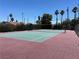 Well-maintained tennis court with vibrant green surface and classic net at 1866 Camino Verde Ln, Las Vegas, NV 89119