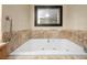 Luxurious bathroom featuring a large tub with marble surround and a modern mirror at 2000 N Fashion Show Dr # 5617, Las Vegas, NV 89109