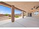 Relaxing covered back patio with ceiling fans, offering views of the desert landscape and serene surroundings at 2031 Silver St, Pahrump, NV 89048