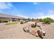 Spacious backyard with a fire pit, desert landscaping, and mature trees offering tranquility at 2031 Silver St, Pahrump, NV 89048