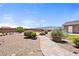 Expansive backyard with desert landscaping, stone walkways, a charming fire pit, and privacy at 2031 Silver St, Pahrump, NV 89048