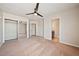 Spacious bedroom with carpet, fan, walk in closet, and ensuite bathroom at 2031 Silver St, Pahrump, NV 89048