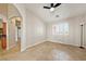 Bonus room with tile flooring, a ceiling fan, and a view of a window with plantation shutters at 2031 Silver St, Pahrump, NV 89048