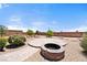 Backyard fire pit surrounded by desert landscaping, perfect for gathering and enjoying the outdoors at 2031 Silver St, Pahrump, NV 89048