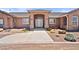 Inviting home exterior with a grand entrance and desert landscaping at 2031 Silver St, Pahrump, NV 89048