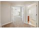Hallway view into a large bedroom with a ceiling fan and a doorway into the kitchen at 2031 Silver St, Pahrump, NV 89048